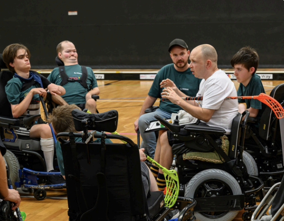People playing powerchair hockey People playing powerchair hockey