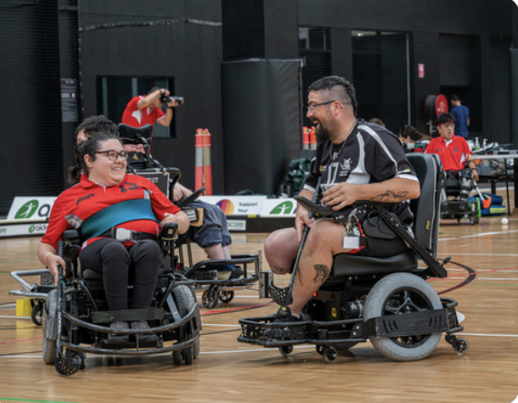Two people playing powerchair hockey Two people playing powerchair hockey